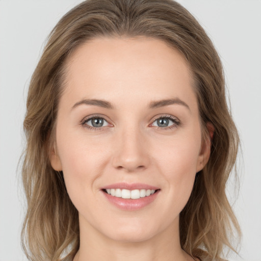 Joyful white young-adult female with long  brown hair and grey eyes