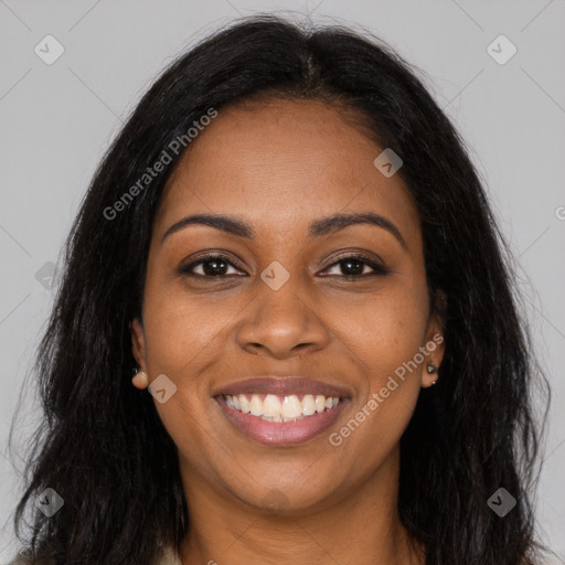 Joyful black young-adult female with long  brown hair and brown eyes