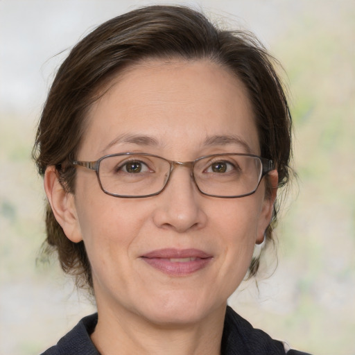 Joyful white adult female with medium  brown hair and brown eyes