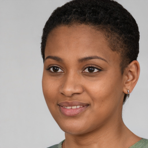 Joyful black young-adult female with short  black hair and brown eyes