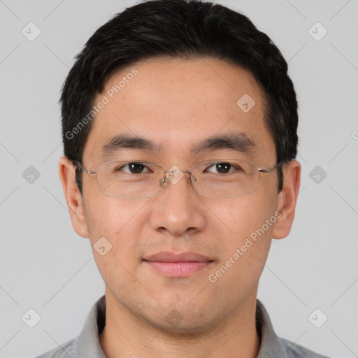 Joyful asian young-adult male with short  brown hair and brown eyes