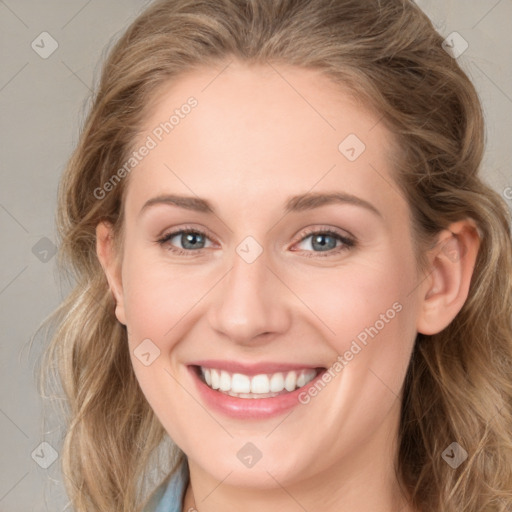 Joyful white young-adult female with long  brown hair and blue eyes