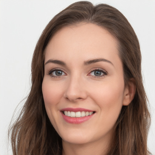 Joyful white young-adult female with long  brown hair and blue eyes