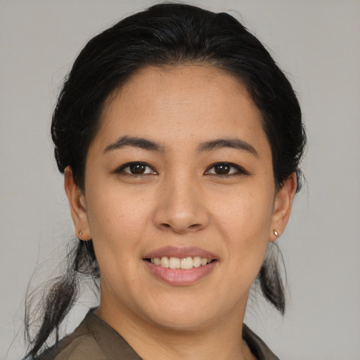 Joyful asian young-adult female with medium  black hair and brown eyes
