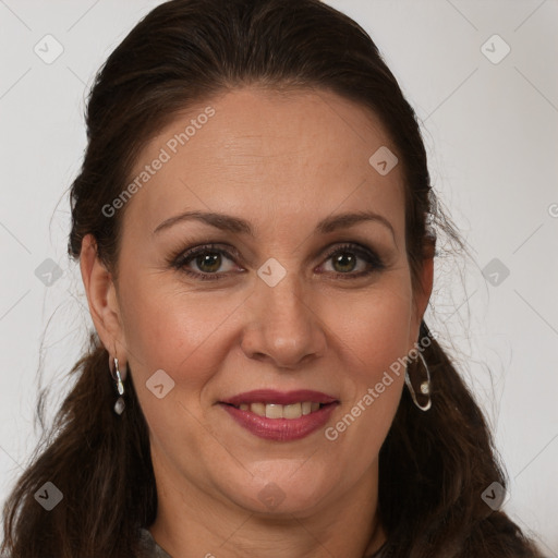 Joyful white adult female with long  brown hair and brown eyes