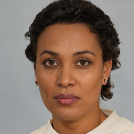 Neutral latino adult female with short  brown hair and brown eyes