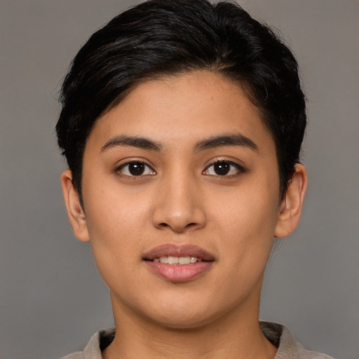Joyful latino young-adult female with short  brown hair and brown eyes