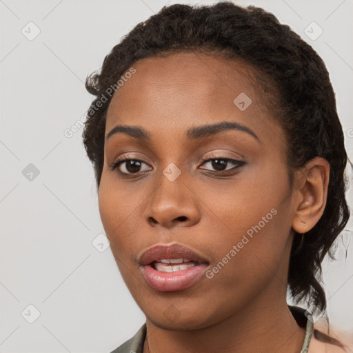 Joyful black young-adult female with short  brown hair and brown eyes