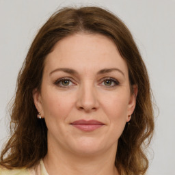 Joyful white young-adult female with medium  brown hair and green eyes