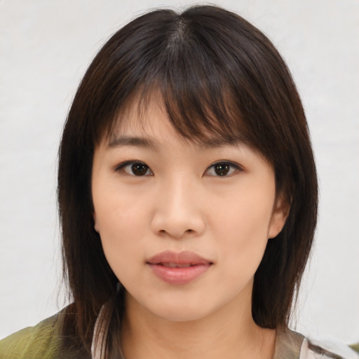 Neutral asian young-adult female with medium  brown hair and brown eyes