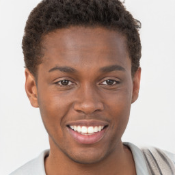 Joyful black young-adult male with short  brown hair and brown eyes