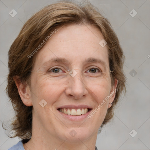 Joyful white adult female with medium  brown hair and grey eyes