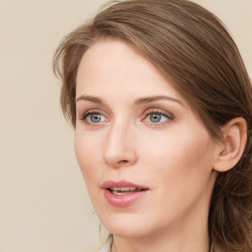 Joyful white young-adult female with long  brown hair and green eyes