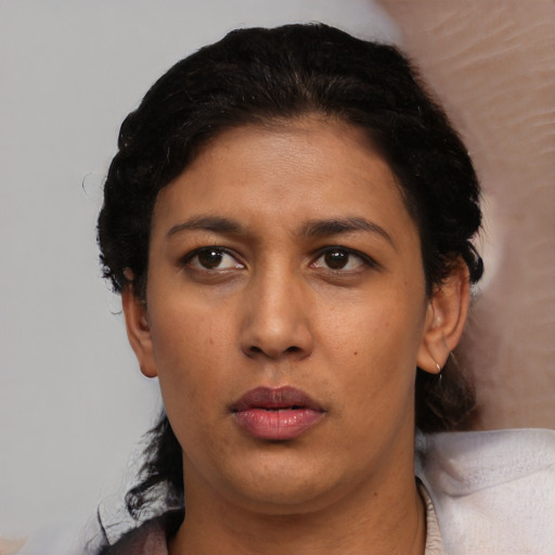 Neutral latino adult female with short  black hair and brown eyes