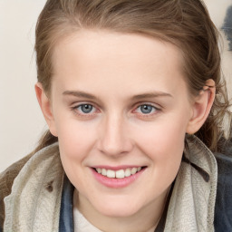 Joyful white young-adult female with medium  brown hair and blue eyes