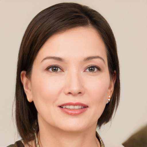 Joyful white young-adult female with medium  brown hair and brown eyes