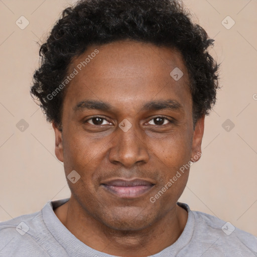 Joyful black young-adult male with short  brown hair and brown eyes