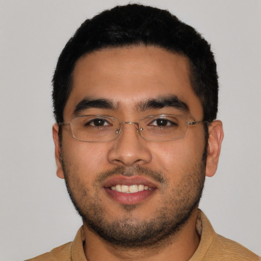 Joyful latino young-adult male with short  black hair and brown eyes