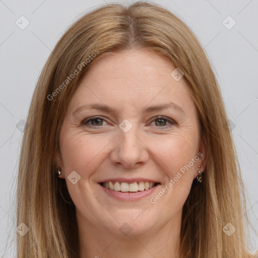 Joyful white adult female with long  brown hair and brown eyes