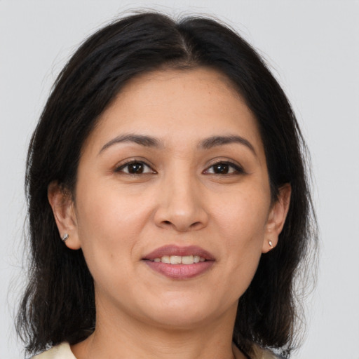 Joyful white adult female with medium  brown hair and brown eyes