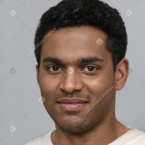 Joyful black young-adult male with short  black hair and brown eyes