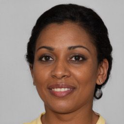 Joyful black young-adult female with short  brown hair and brown eyes