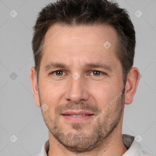 Joyful white adult male with short  brown hair and brown eyes