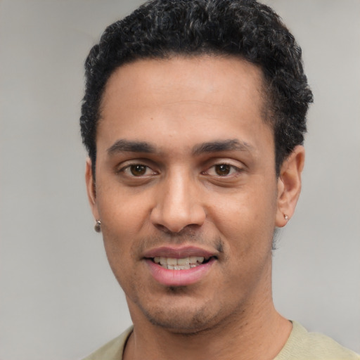 Joyful white young-adult male with short  black hair and brown eyes