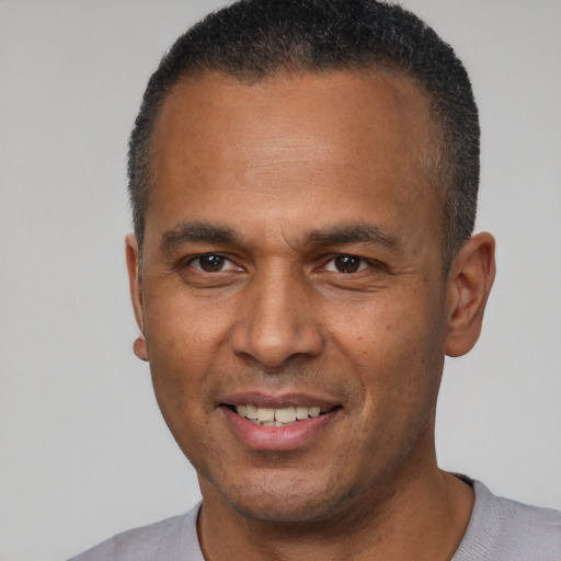 Joyful latino adult male with short  brown hair and brown eyes