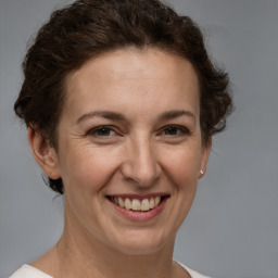 Joyful white adult female with short  brown hair and brown eyes