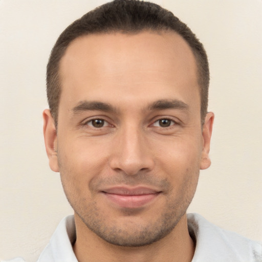 Joyful white young-adult male with short  brown hair and brown eyes