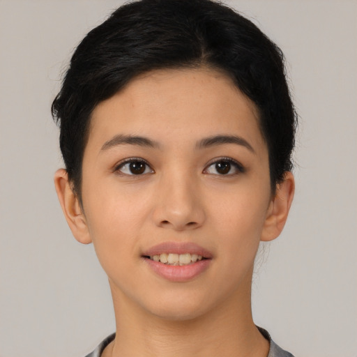 Joyful asian young-adult female with short  black hair and brown eyes