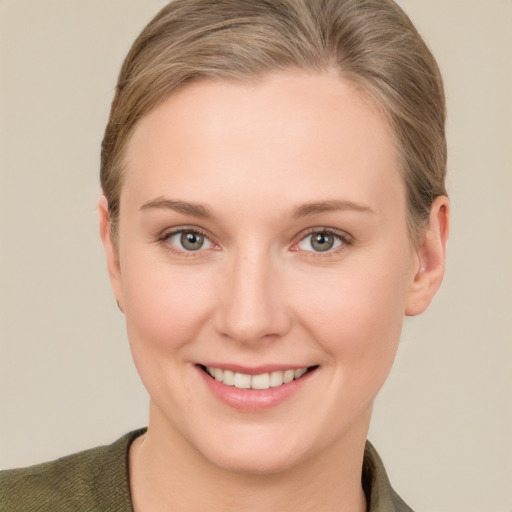 Joyful white young-adult female with short  brown hair and grey eyes