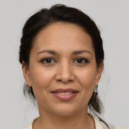 Joyful white adult female with medium  brown hair and brown eyes