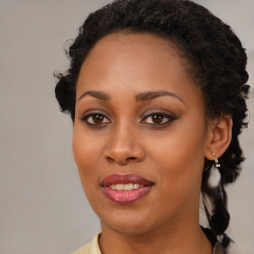 Joyful black young-adult female with medium  black hair and brown eyes