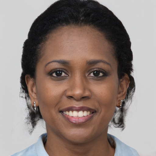 Joyful black young-adult female with medium  brown hair and brown eyes
