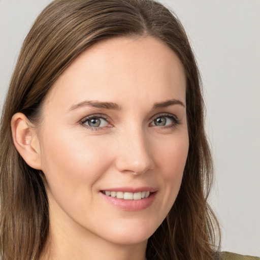 Joyful white young-adult female with long  brown hair and brown eyes