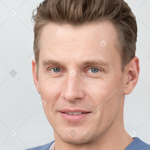 Joyful white adult male with short  brown hair and grey eyes