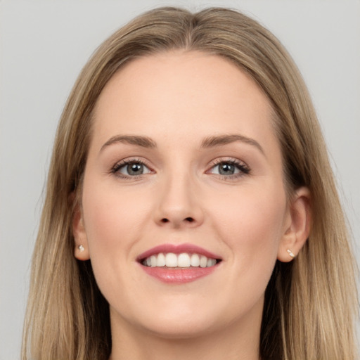 Joyful white young-adult female with long  brown hair and grey eyes