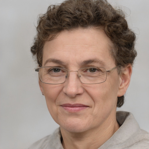 Joyful white adult female with short  brown hair and green eyes