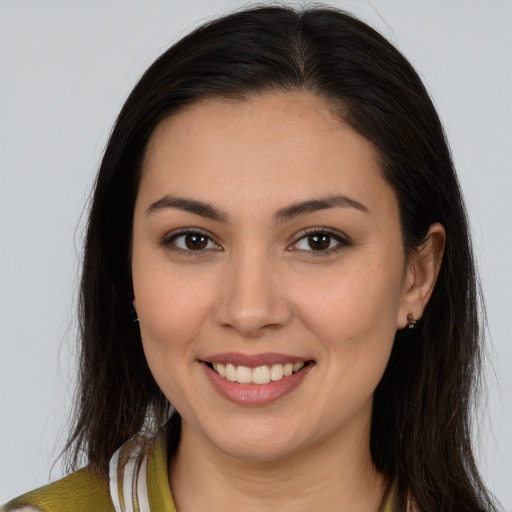 Joyful white young-adult female with long  brown hair and brown eyes