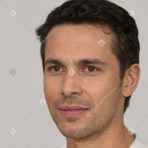 Joyful white adult male with short  brown hair and brown eyes