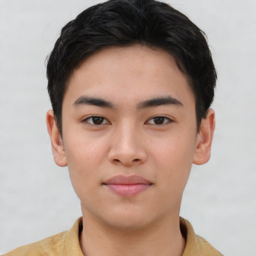 Joyful asian young-adult male with short  brown hair and brown eyes