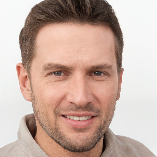 Joyful white adult male with short  brown hair and grey eyes