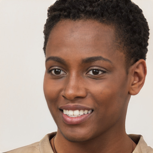 Joyful black young-adult female with short  brown hair and brown eyes