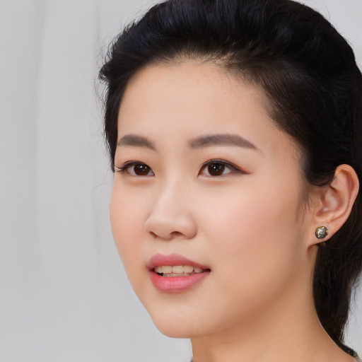 Joyful white young-adult female with medium  black hair and brown eyes