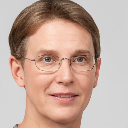 Joyful white adult male with short  brown hair and grey eyes