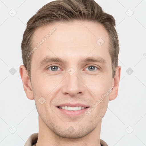 Joyful white young-adult male with short  brown hair and grey eyes