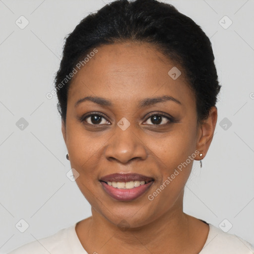 Joyful black young-adult female with short  black hair and brown eyes