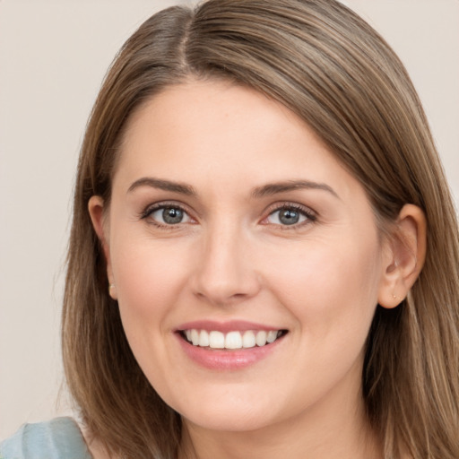 Joyful white young-adult female with long  brown hair and brown eyes